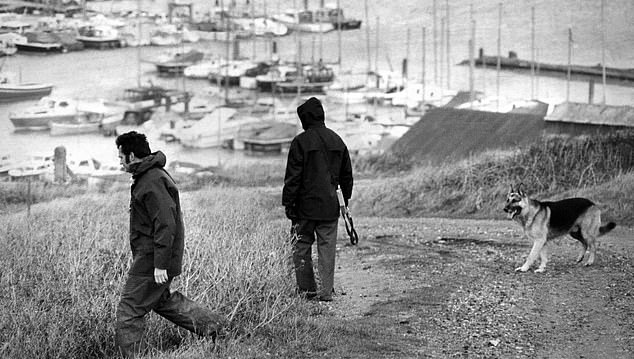 Pictured: Police dog handlers search for Lord Lucan on the hills above Newhaven Harbor after the aristocrat's disappearance