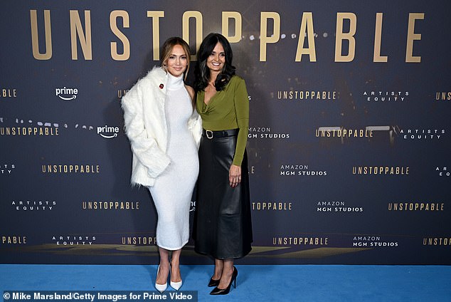 On Tuesday, the Emmy-nominated producer served up Basic Instinct realness in a white Magda Butrym halter dress as he posed with Judy Robles (R) at the UK premiere of Unstoppable