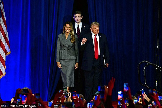 Donald Trump arrives at an election night event on Wednesday with former First Lady Melania Trump and his son Barron Trump