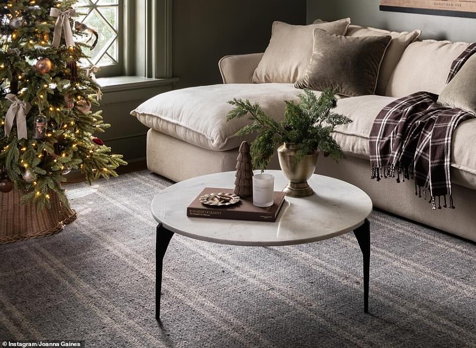 Another room had an arrangement of Christmas tree centerpieces in a copper vase with a wooden tree next to it