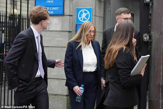 Nikita Ni Laimhin (centre) outside the High Court in Dublin on Tuesday, where Mixed Martial Arts fighter Conor McGregor appears for a personal injury case against him