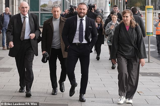 Conor McGregor (second from right) with his father Tony McGregor (second from left) outside the High Court in Dublin on November 6