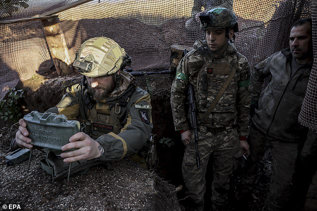 A Ukrainian soldier places a claymore landmine along the front line in the Donetsk region, October 30