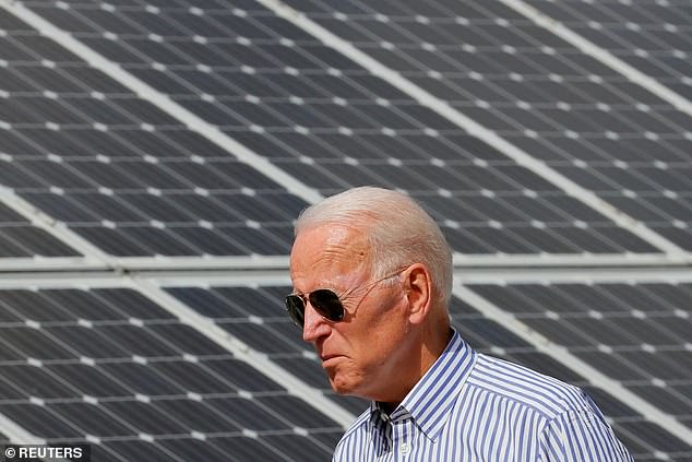 Above: Current President Joe Biden walks past solar panels during a tour of the Plymouth Area Renewable Energy Initiative in Plymouth, New Hampshire in 2020 while running for office