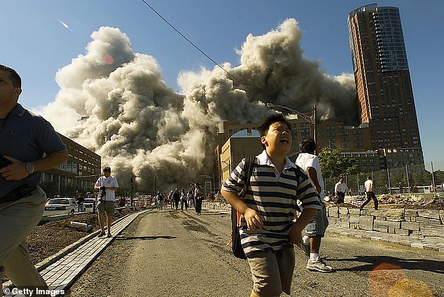 People run away as the North Tower of the World Trade Center collapses on September 11, 2001