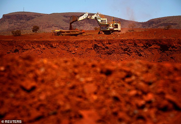 US tariffs on Chinese goods could lead to lower demand for Australian exports such as iron. An iron ore mine in Port Hedland, WA is shown