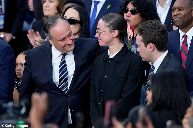 Emhoff hugged his children, Ella and Cole, during the speech