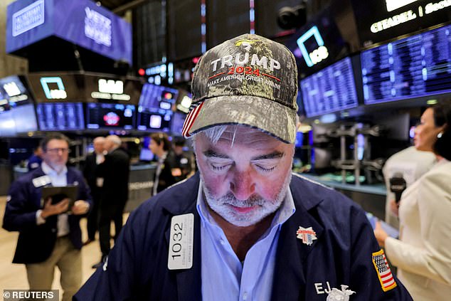 A trader wears a hat in support of Republican Donald Trump, after he won the US presidential election, at the New York Stock Exchange in New York City, USA, November 6, 2024