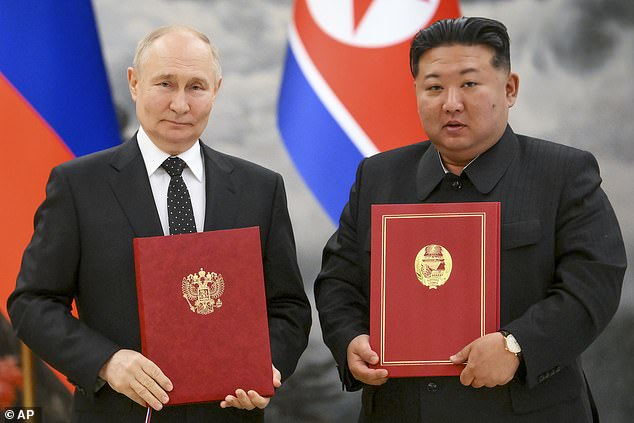 Russian President Vladimir Putin (left) and North Korean leader Kim Jong Un pose for a photo during a signing ceremony of the new partnership in Pyongyang, North Korea, on June 19, 2024