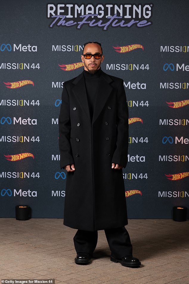 Lewis looked sharp in a double-breasted trench coat that he paired with a turtleneck sweater