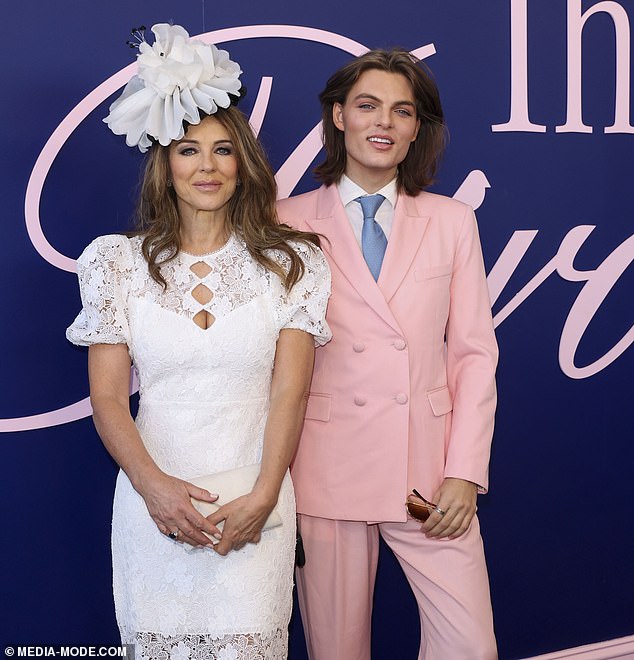 Liz embraced race day style as she secured a huge white floral fascinator into her brunette locks, ensuring she turned heads in her chic ensemble