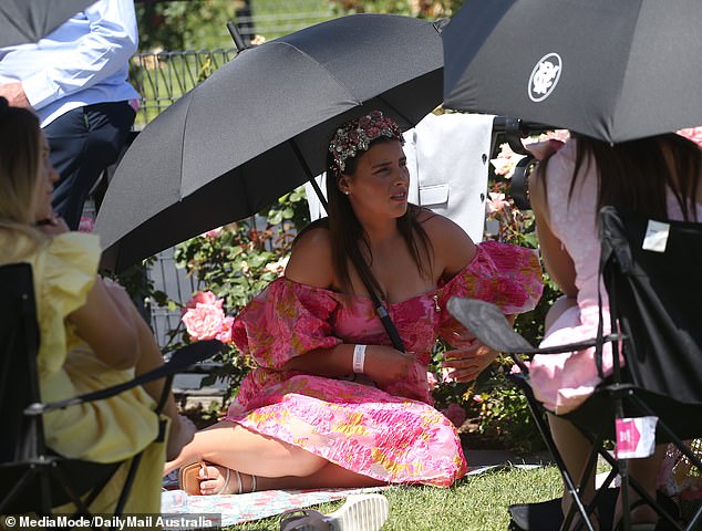 Revelers who remembered to bring an umbrella were grateful as showers passed through Flemington on Thursday afternoon