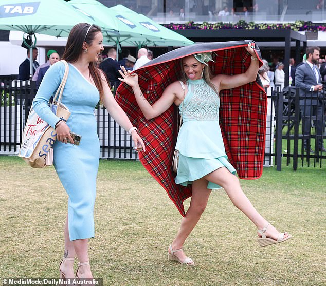 While an umbrella is usually the cover of choice for racegoers, some attendees used whatever they could find to protect their outfits