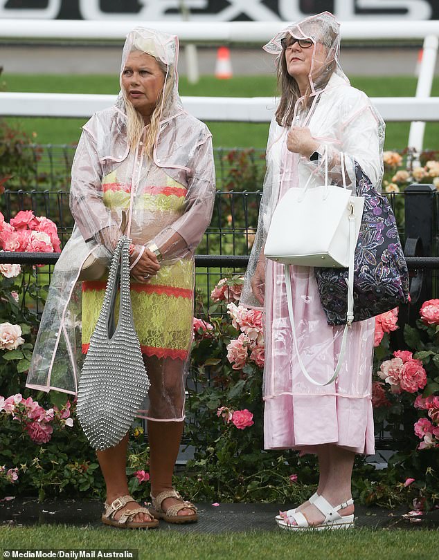 Well-prepared race participants brought umbrellas and raincoats