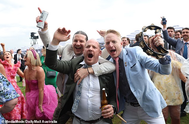 Winners are grinners! Dancing partygoers on Thursday had no fear that the grass would turn to mud