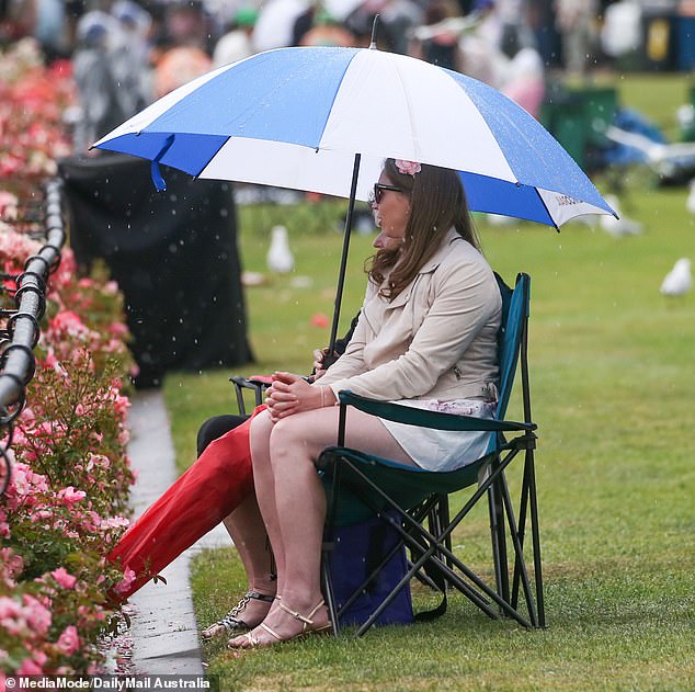 Prepared participants were able to enjoy the races on the track, while others were forced to hide undercover from the rain