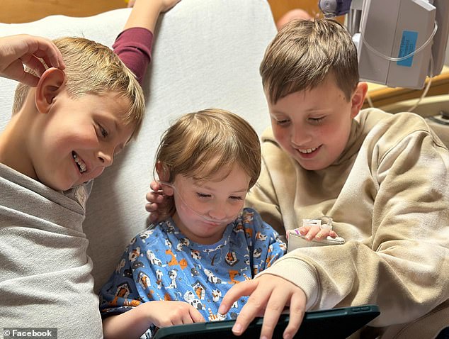 In the US, Alma Geddes, centre, is pictured with her brothers as she remains in a hospital in Baltimore where she was being treated for Mycoplasma pneumonia.