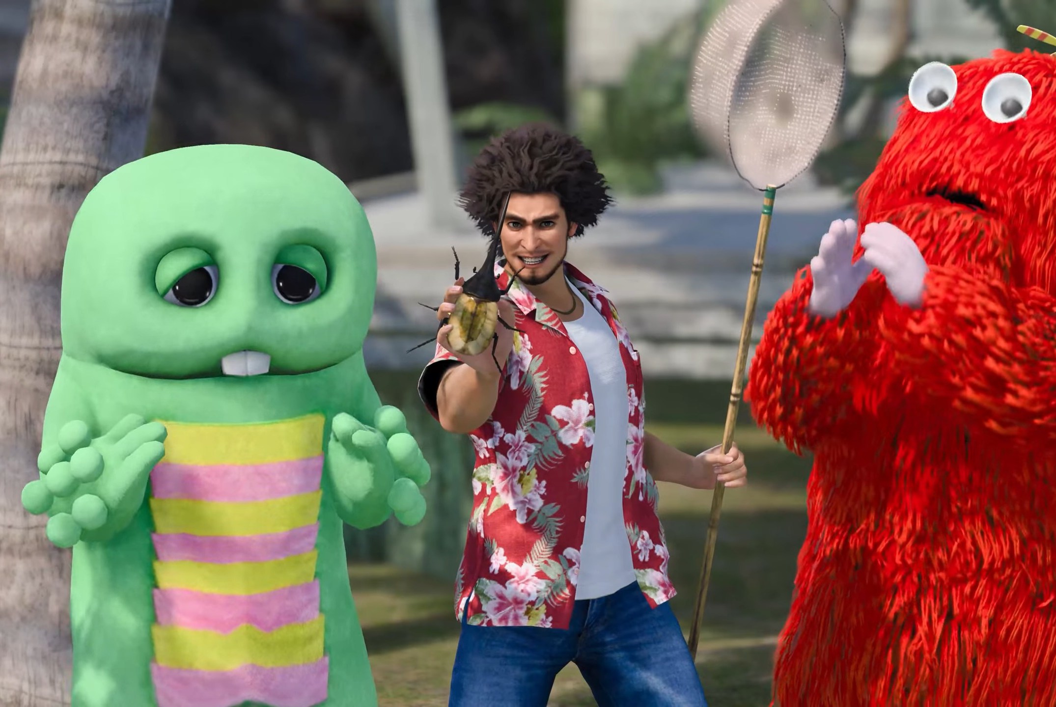 Ichiban Kasuga holds up a beetle he caught with a net, and is flanked by mascots Gachapin and Mukku, in a screenshot from Like A Dragon: Infinite Wealth.