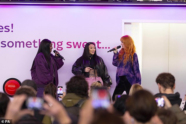 The girl group shocked passers-by when they emerged from a large Sky Broadband platform in the train station