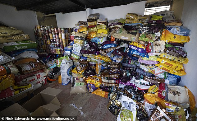 The center, which houses dozens of animals, contains piles of donated pet food