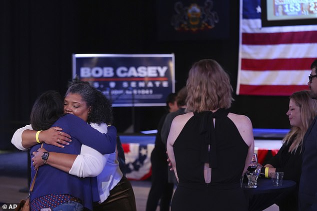 Casey supporters embrace as they leave his election night watch party in Scranton, PA before the race is called