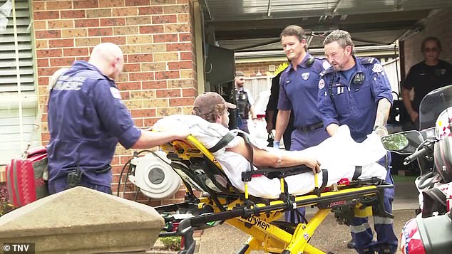 Police officers helped NSW ambulance crews remove the man from the roof where he had been working