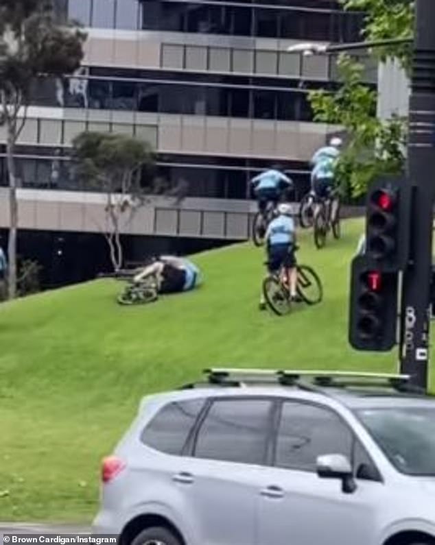 Eight NSW police officers were cycling up the steep slope in Sydney when one of them started to lose his balance and tripped (pictured)