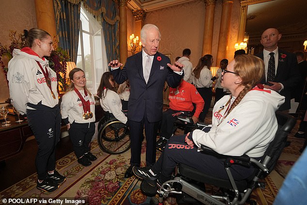 King Charles talks to guests today at the event at Buckingham Palace