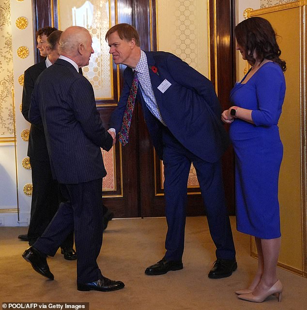 King Charles shakes hands with Stephen Timms, Minister of State for Social Security and Disability