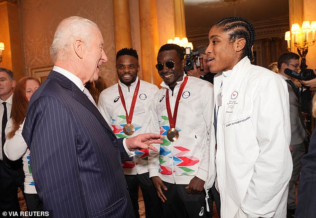 King Charles beams as he speaks to medalists at Buckingham Palace