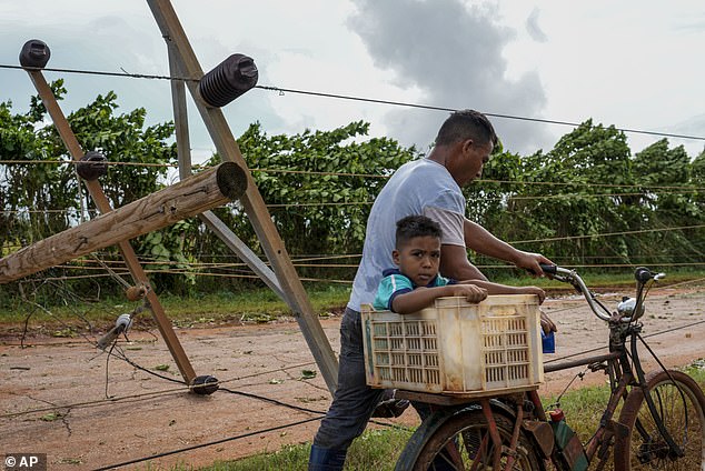 Rafael withdrew from Cuba on Thursday and entered the Gulf of Mexico as a Category 2 hurricane, leaving behind damaged homes, uprooted trees and downed telephone poles