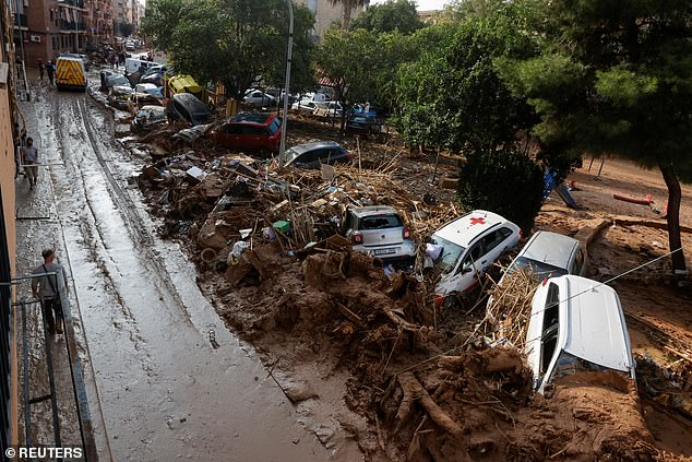 Damaged cars and debris are pictured by the side of a road, after heavy rain causing flooding, in Paiporta, near Valencia, Spain, November 6, 2024