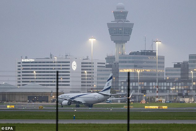 An El Al plane lands on the tarmac of Amsterdam's Schiphol Airport as the Israeli government prepares to evacuate civilians after attacks on football fans