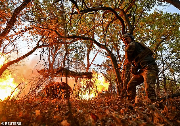 A Ukrainian military member of the Hyzhak (Predator) police special unit fires a D30 howitzer at Russian troops, amid the Russian attack on Ukraine, near the frontline city of Toretsk, Ukraine, October 25, 2024