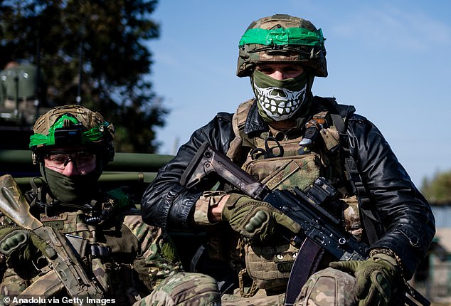 Ukrainian soldiers of the Liut Brigade sit in a pickup truck on their way back to the frontline town near Khasiv Yar in the Donetsk region, Ukraine on October 7, 2024