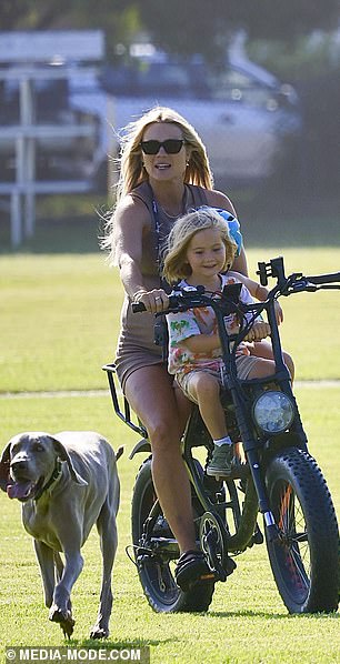 Elyse seemed to be having a great day in the sun, smiling as she rode happily through the park, her hair blowing in the wind