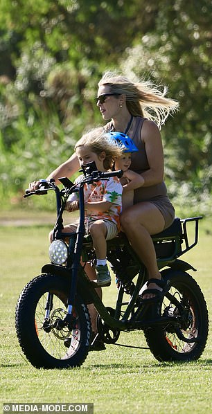 Elyse seemed to be having a great day in the sun, smiling as she rode happily through the park, her hair blowing in the wind