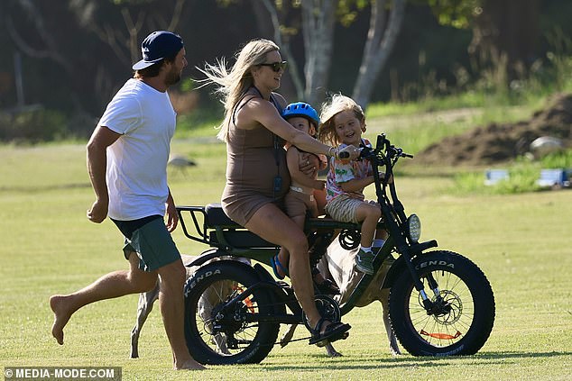 The adventurous model even managed to balance both children on the bike at one point