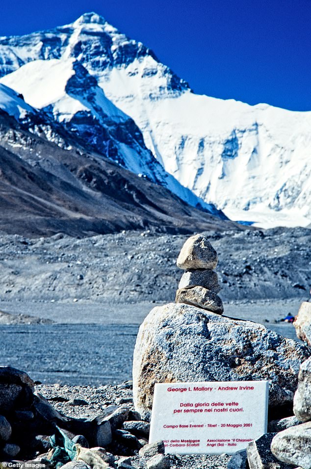 A plaque commemorating George Mallory and Andrew Irvine, placed on Mount Everest by Italian climbers. The inscription reads 'from the glory of the peaks forever in our hearts'