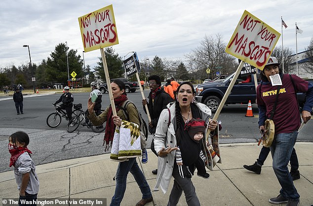 Protesters pictured in 2014 - six years before the team would drop 'Redskins'