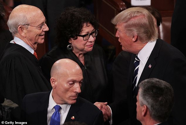 US President Donald Trump greets Stephen Breyer and Supreme Court Associate Justice Sonia Sotomayor after addressing a joint session of the US Congress