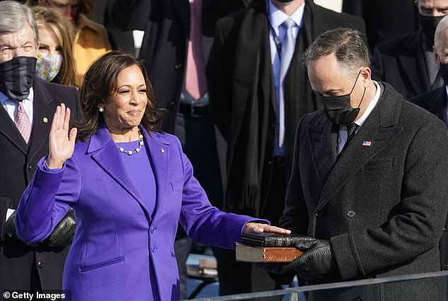 Kamala Harris is sworn in as vice president by Supreme Court Justice Sonia Sotomayor as her husband Doug Emhoff holds the Bible.