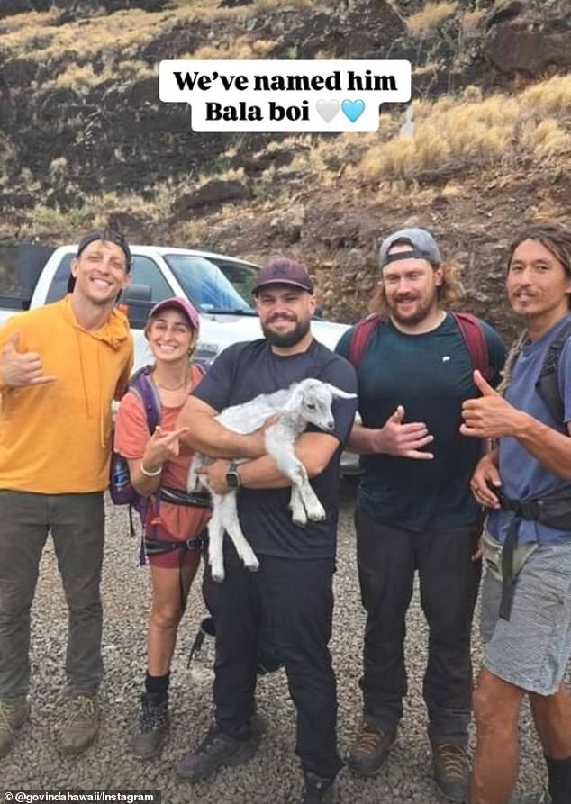 “I was very relieved that we got him safely,” Govinda said. 'We called him Bala. Bala means white. He's beautiful.' In the photo: Rescuers with the baby goat