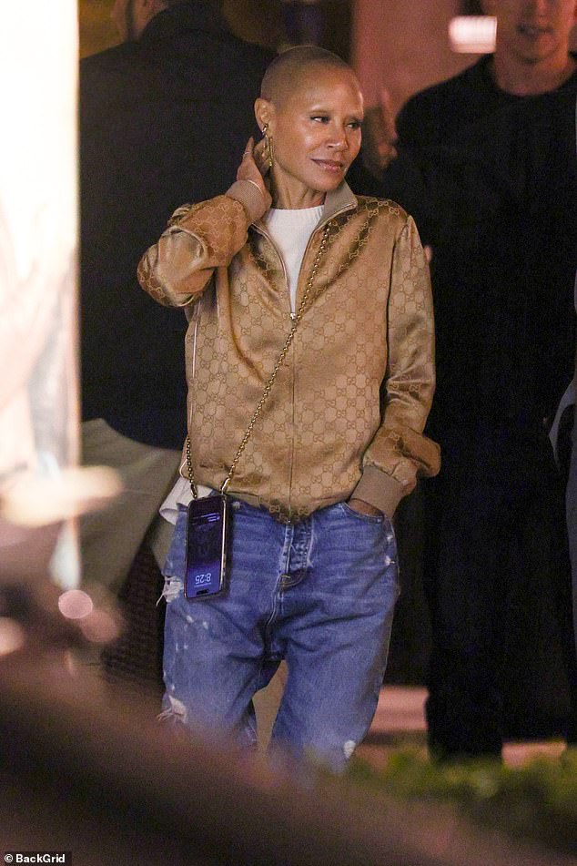 Jada looked casually cool in a gold jacket and jeans as she chatted with her husband, who wore a gray jacket, white T-shirt and pants