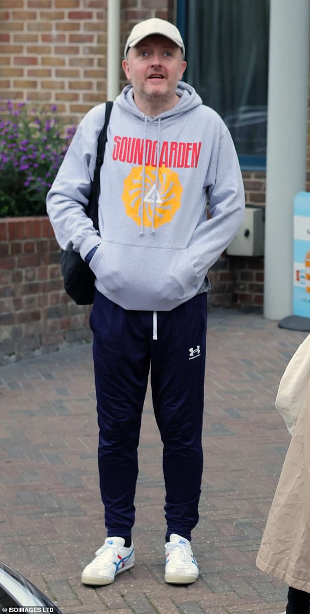 He teamed a pair of white sneakers and a gray baseball cap with his casual ensemble