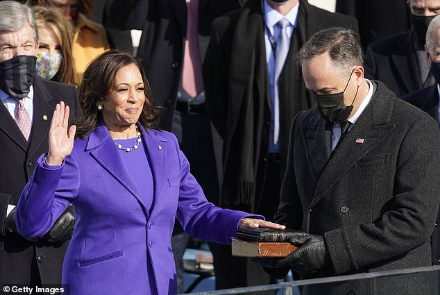 Kamala Harris is sworn in as Vice President by Supreme Court Justice Sonia Sotomayor as her husband Doug Emhoff holds the Bible