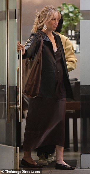 The Oscar winner played up the warm tones in her skin tone by wearing a brown midi dress with V-neck and matching sweater.