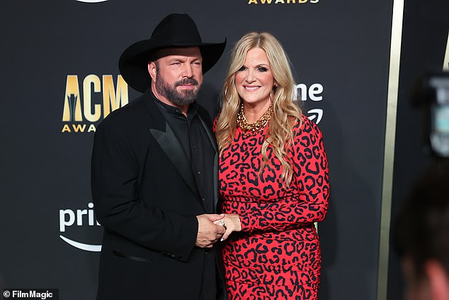 The singer's lawyers claim they want to go to federal court because Jane Roe has filed for more than $75,000 in damages; pictured with wife Trisha Yearwood in May 2023 in Frisco, Texas