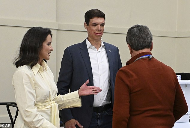 Brown with his wife Amy as they drop off their ballots at a polling station on October 23