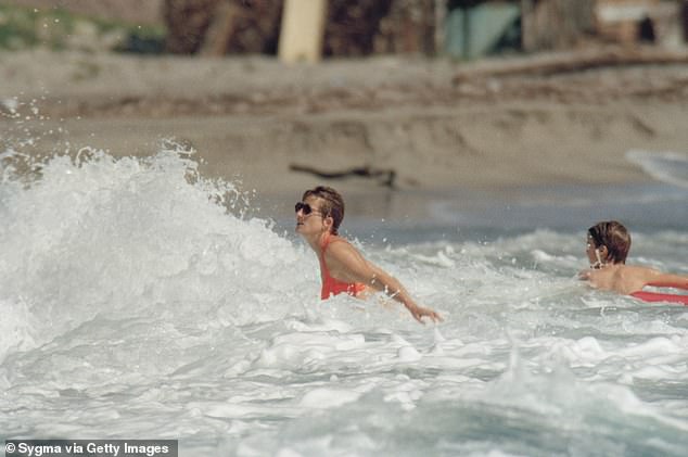 Diana enjoys the sea foam during her holiday with her two sons in January 1993